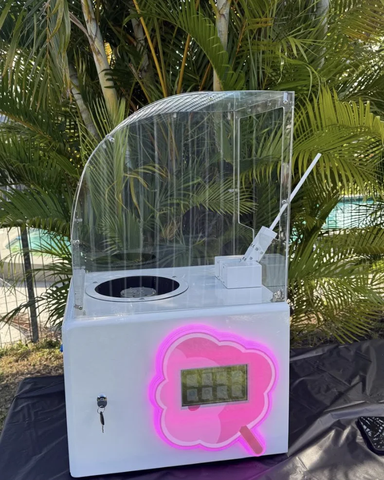 The compact Flossed Fairy machine set up outdoors beside a pool at a Brisbane event